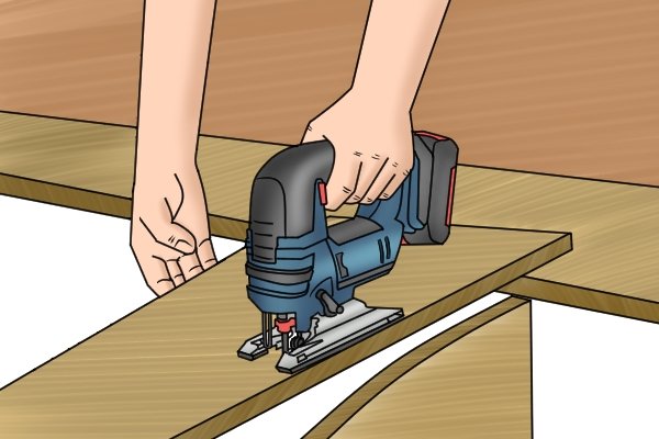 Cordless jigsaw being used to make straight cut in wood